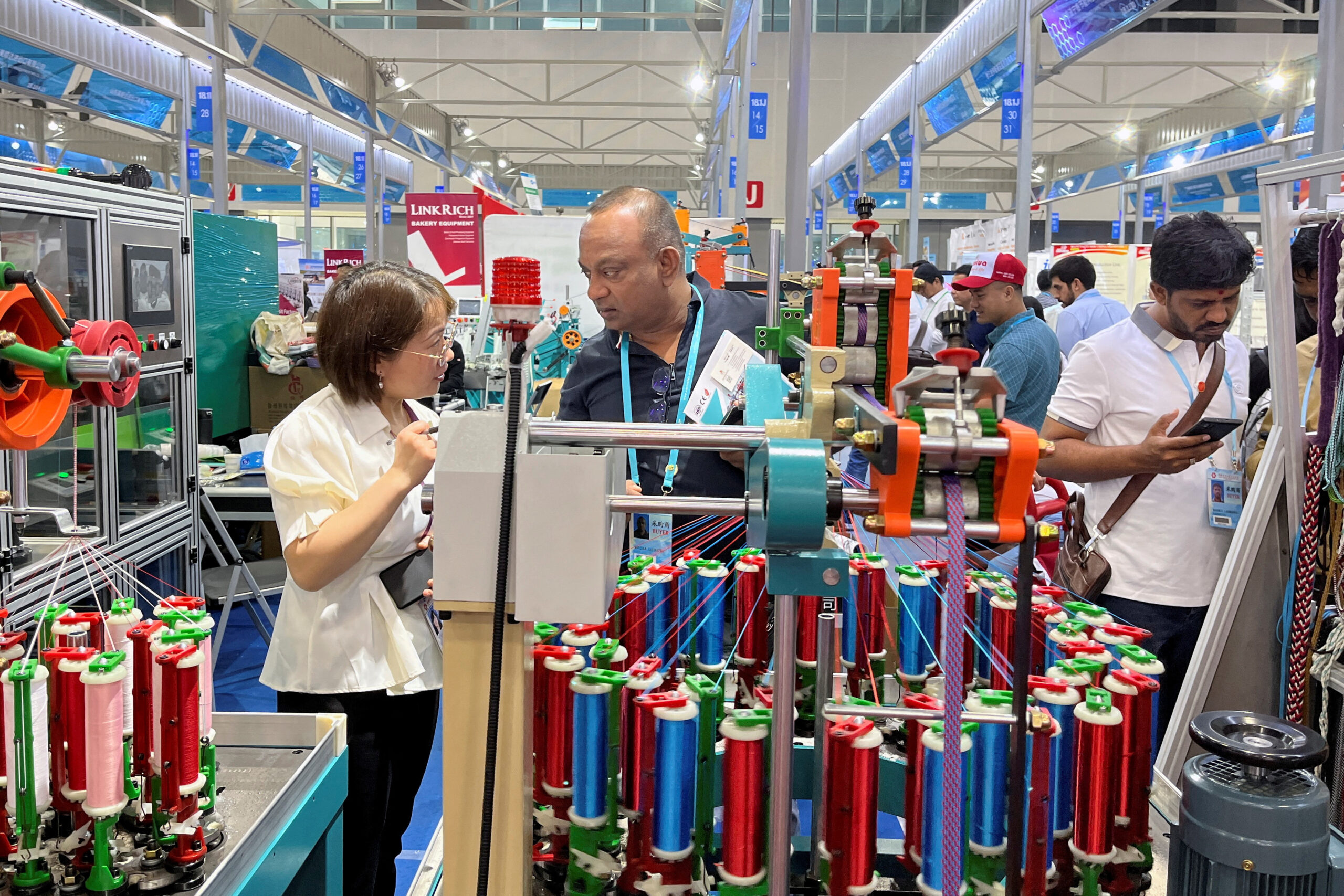 Trade fair product demonstration and supplier discussion